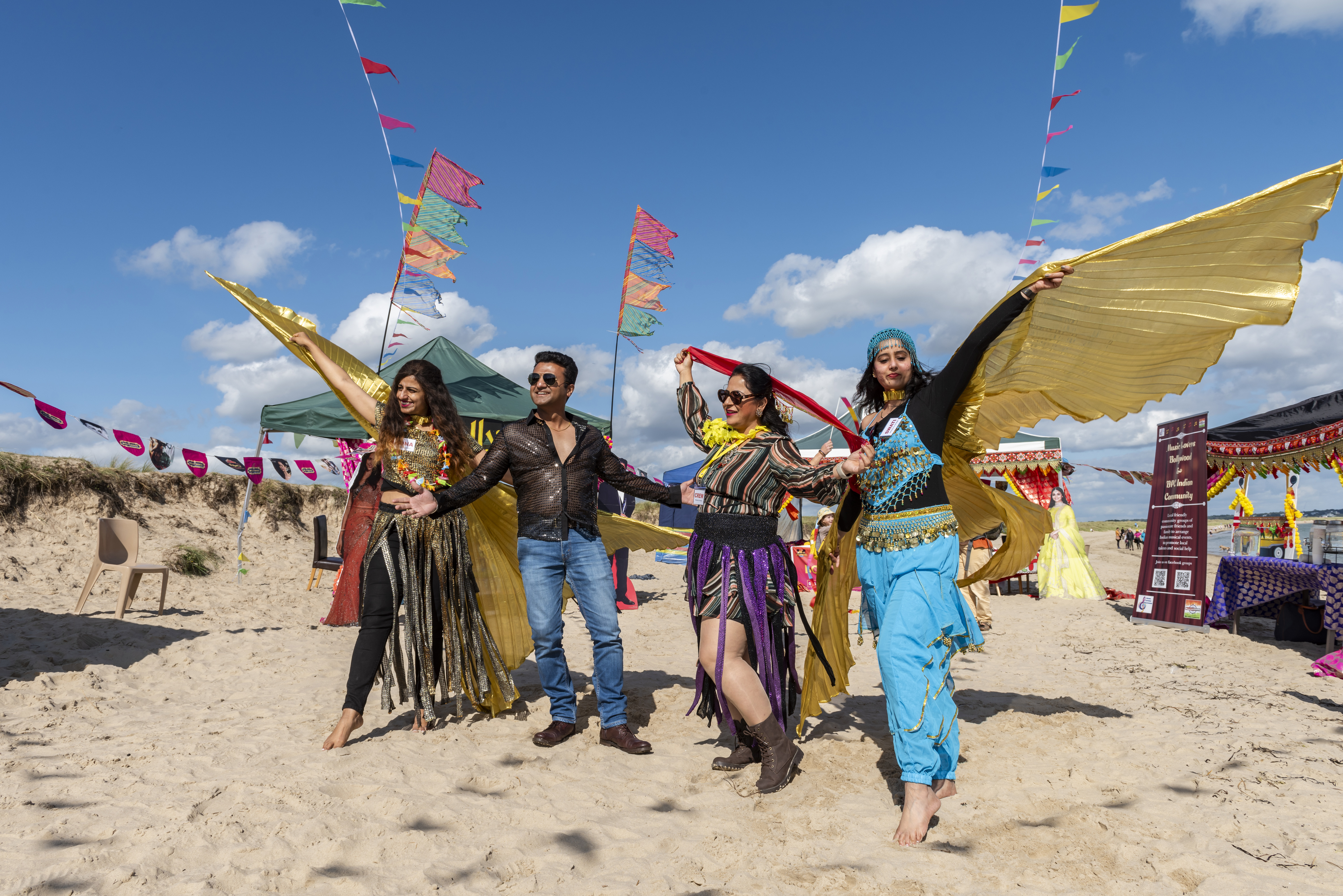 Visitors dancing at the Bollywood on the beach community event at Studland Bay, Dorset Paul Harris